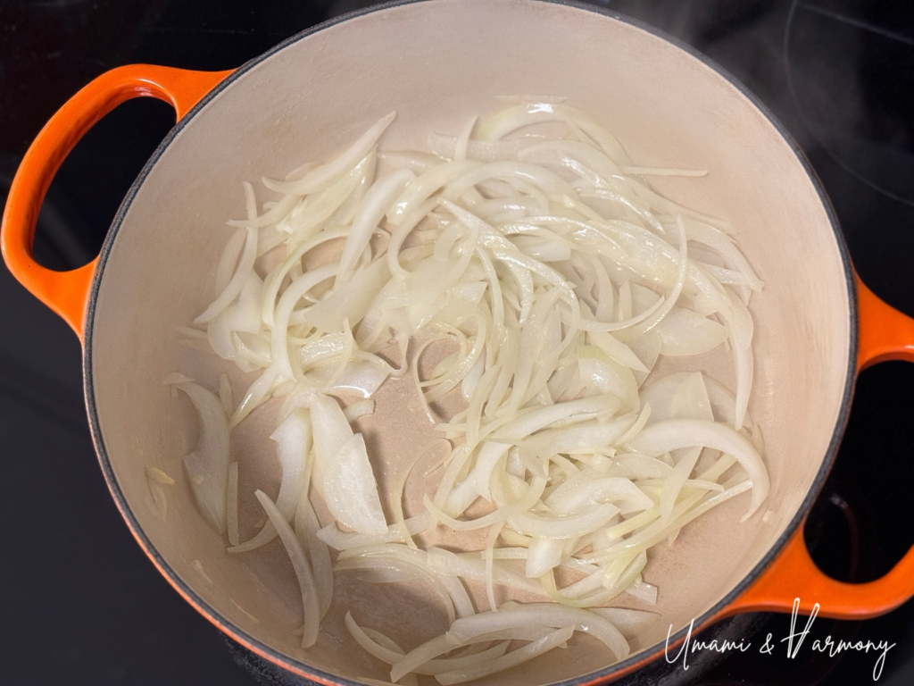 Sliced onion sautéing in butter and olive oil until translucent
