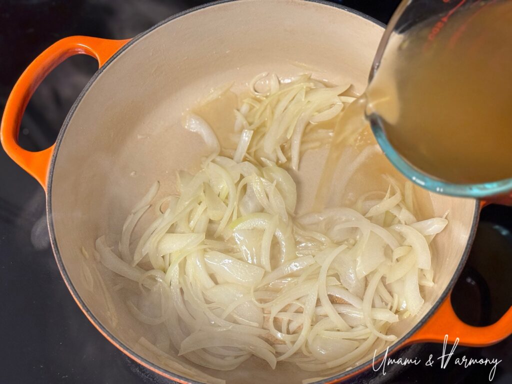 Soup broth being poured into the pot