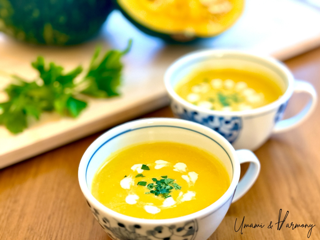 Kabocha squash soup served in a bowl with parsley garnish