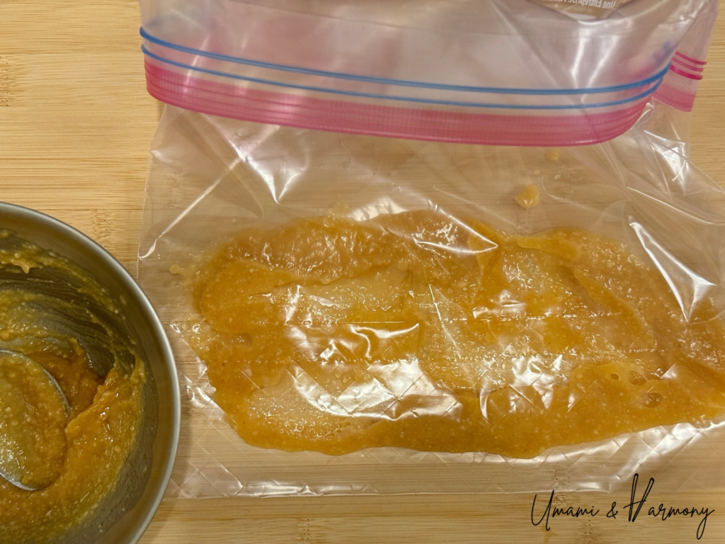 Black cod pieces placed in a zip-top bag with miso marinade