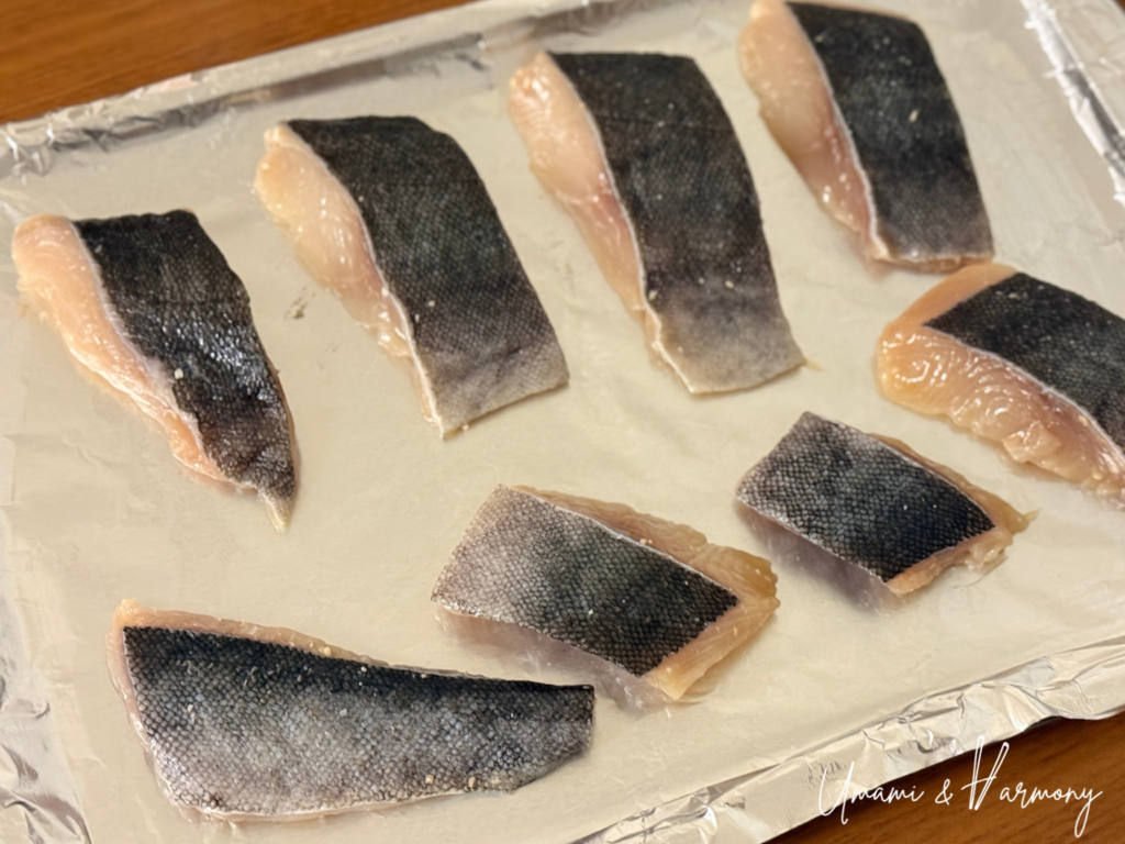Miso-marinated black cod arranged skin-side up on the baking pan
