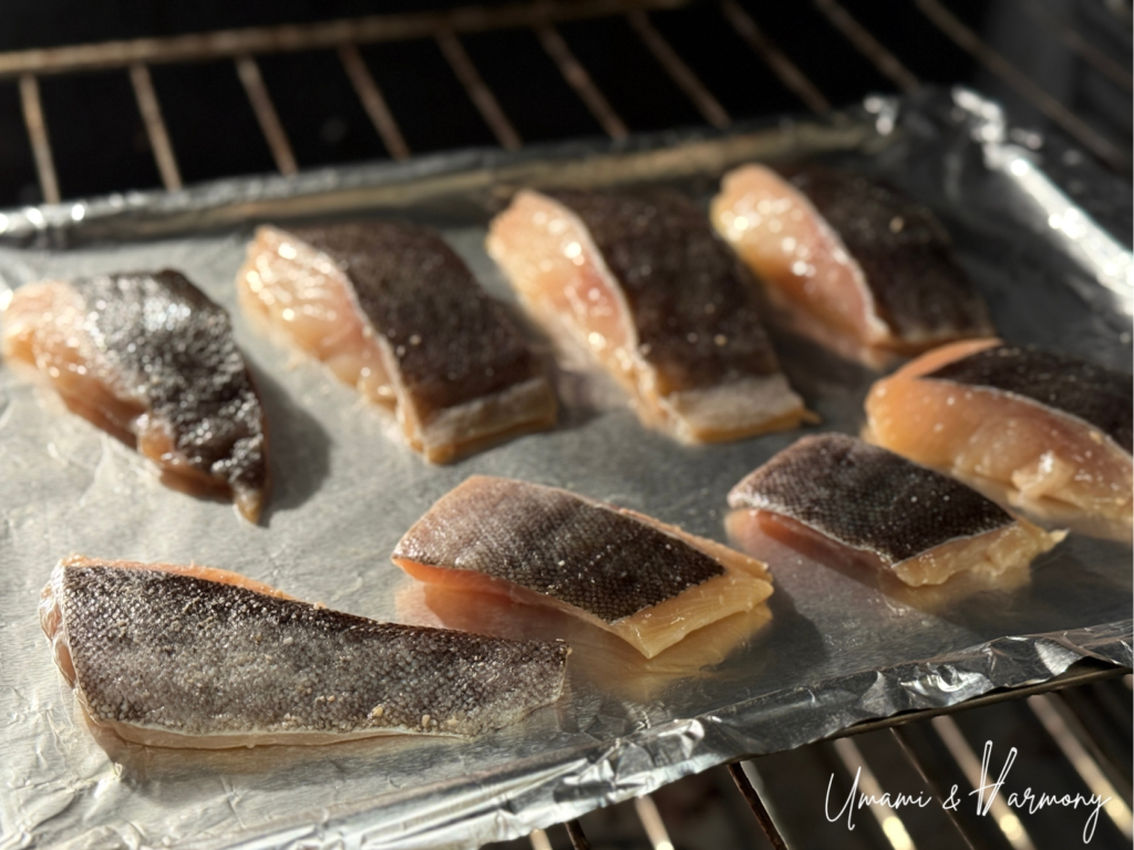 Miso-marinated black cod baking in the oven on a foil-lined pan
