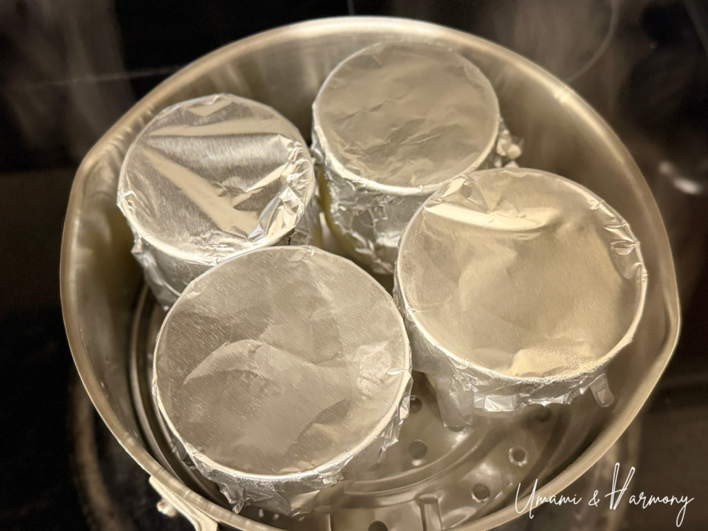 Purin cups covered with aluminum foil ready for steaming