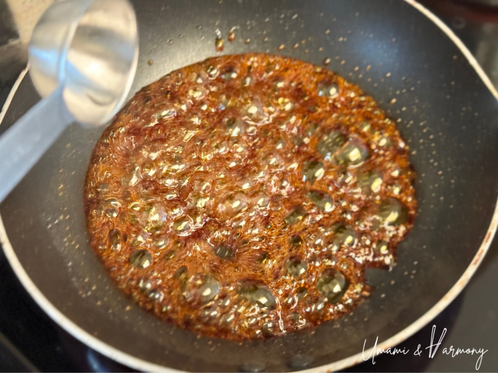 Hot water being carefully added to caramel sauce