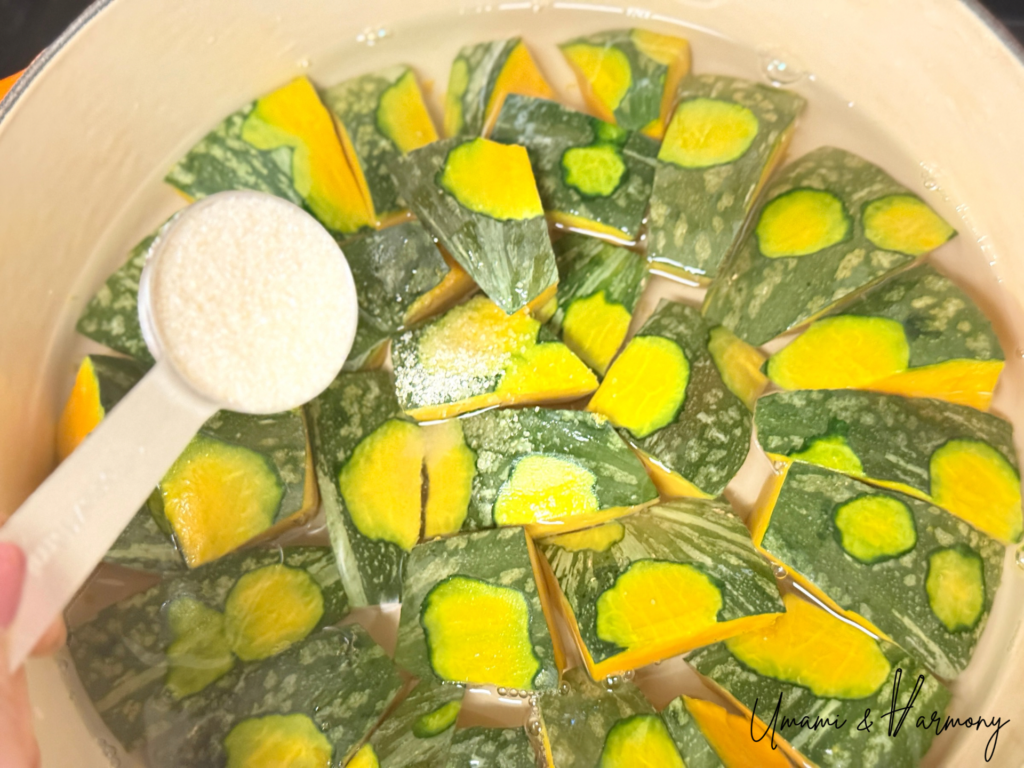 Soy sauce, sake, mirin, and sugar added to Kabocha in a pot
