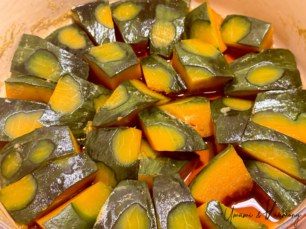 Tender braised Kabocha coated in reduced glaze in the pot