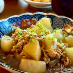 Simmered Daikon with Chicken Soboro served in a bowl