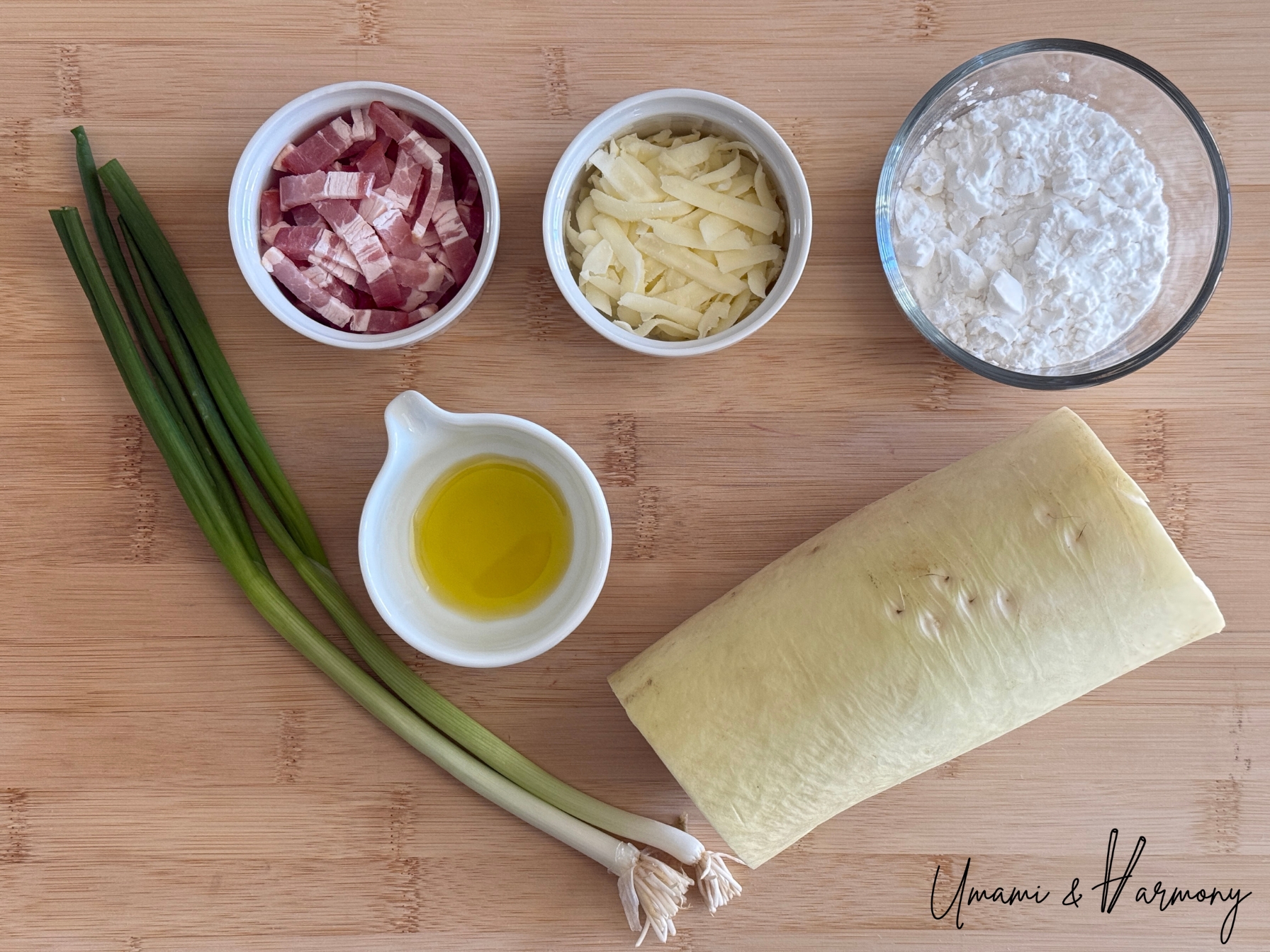 Ingredients for daikon mochi including daikon radish, starch, bacon, cheese, green onions and olive oil