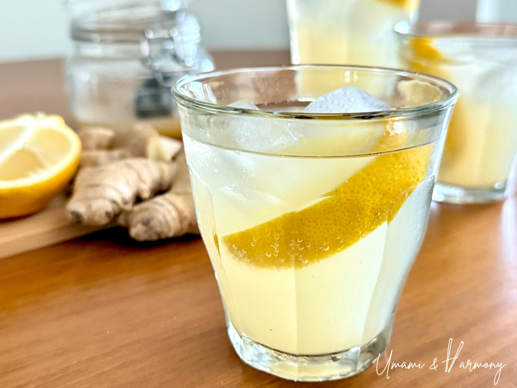 Homemade ginger ale served over ice with lemon wedge in a glass