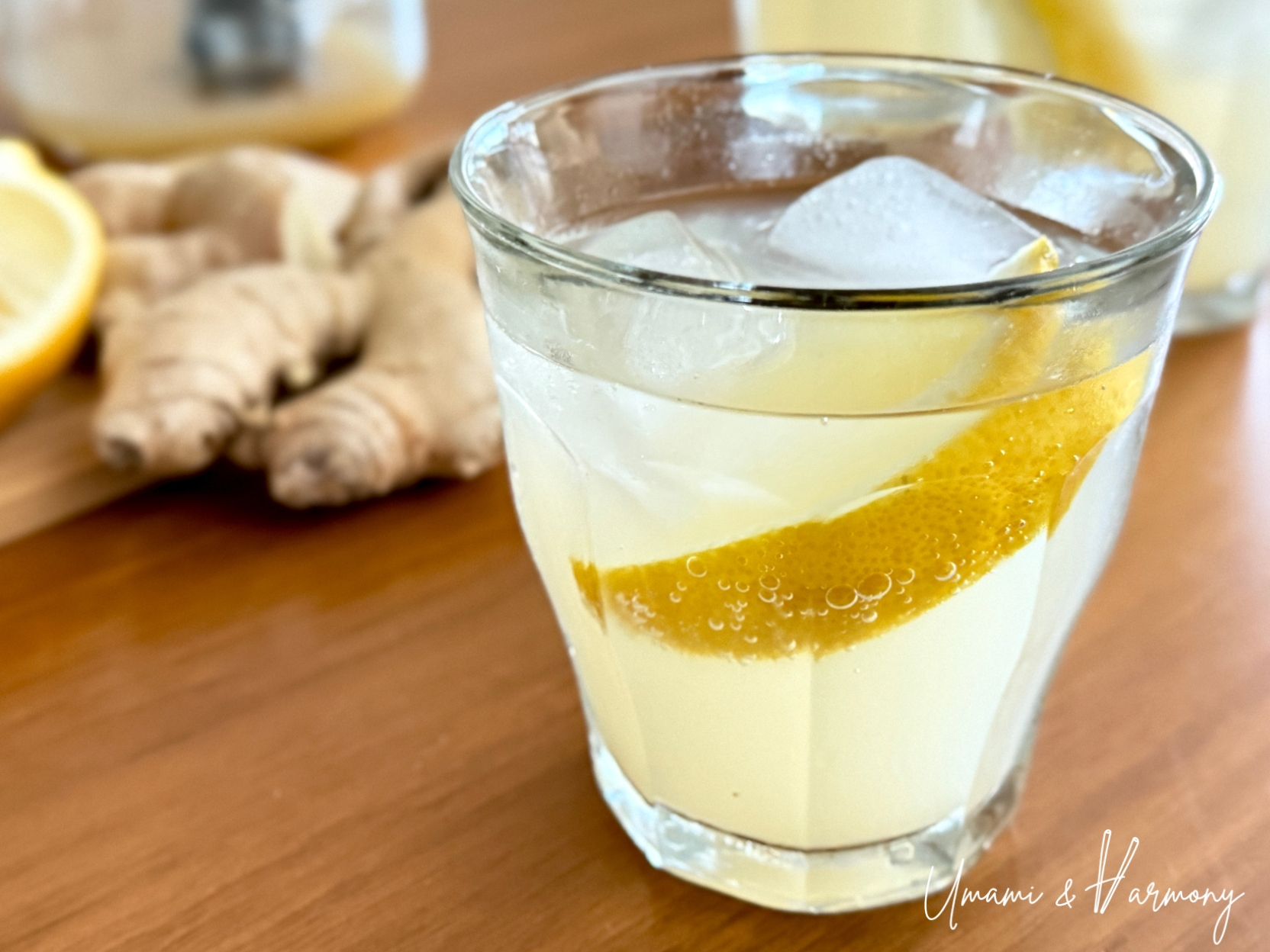 Glass of homemade ginger ale served with ice and a lemon wedge