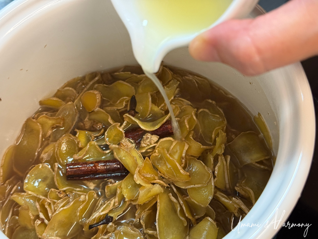 Fresh lemon juice being added into simmering ginger syrup