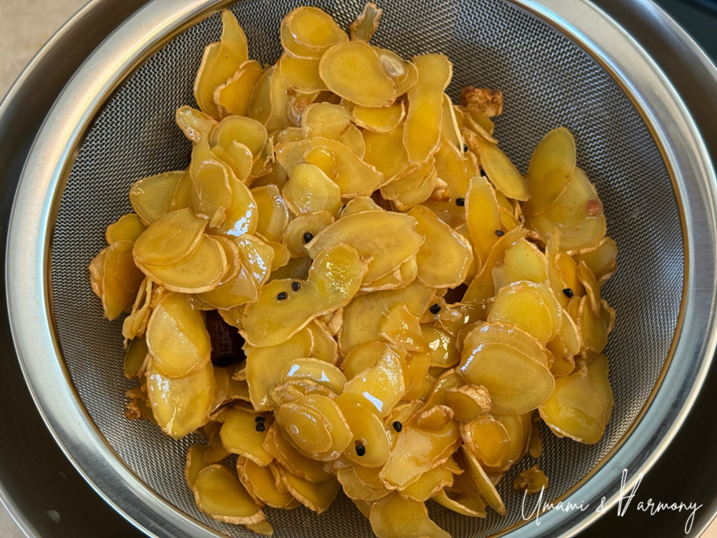 Ginger syrup being strained through a fine mesh strainer