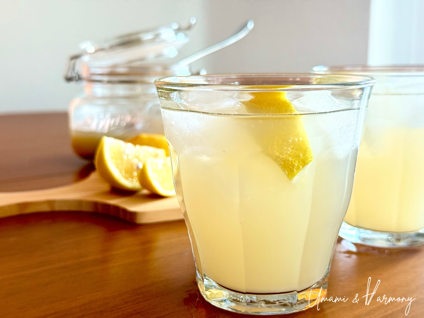 Glass of homemade ginger ale served with ice and a lemon wedge