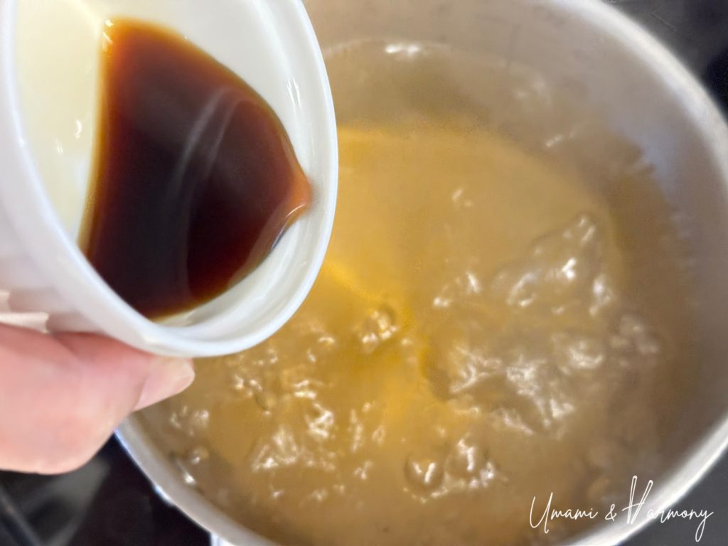 Soy sauce being added to dashi broth