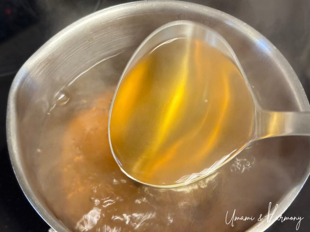 Golden-colored dashi after seasoning with soy sauce