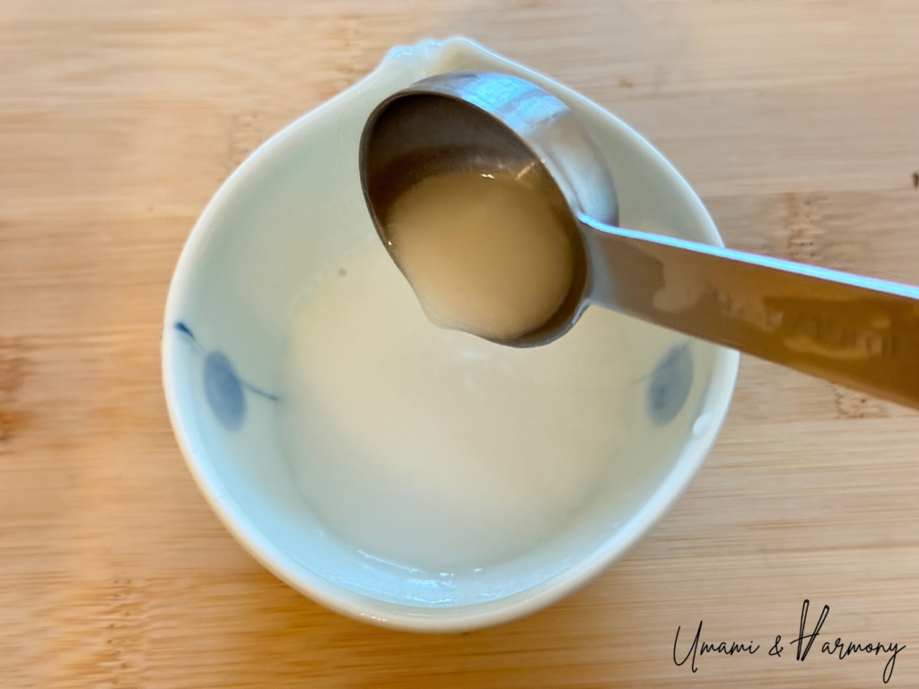 Potato starch and water mixed into a smooth slurry in a small bowl