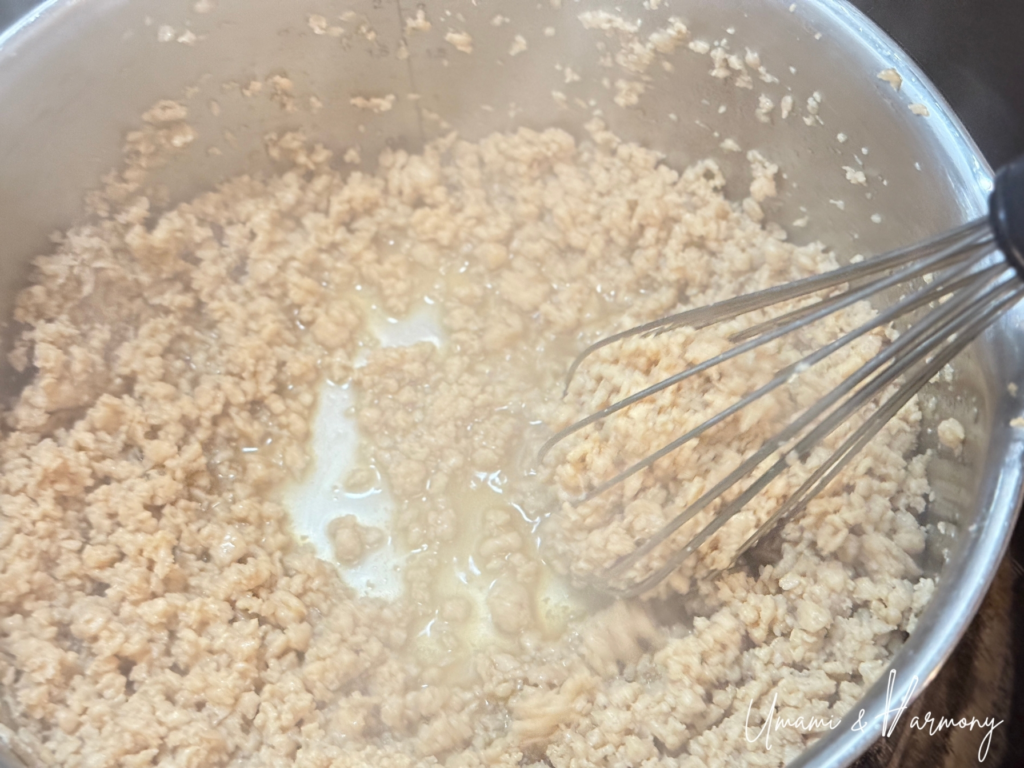 Chicken soboro cooking as juices reduce and become glossy