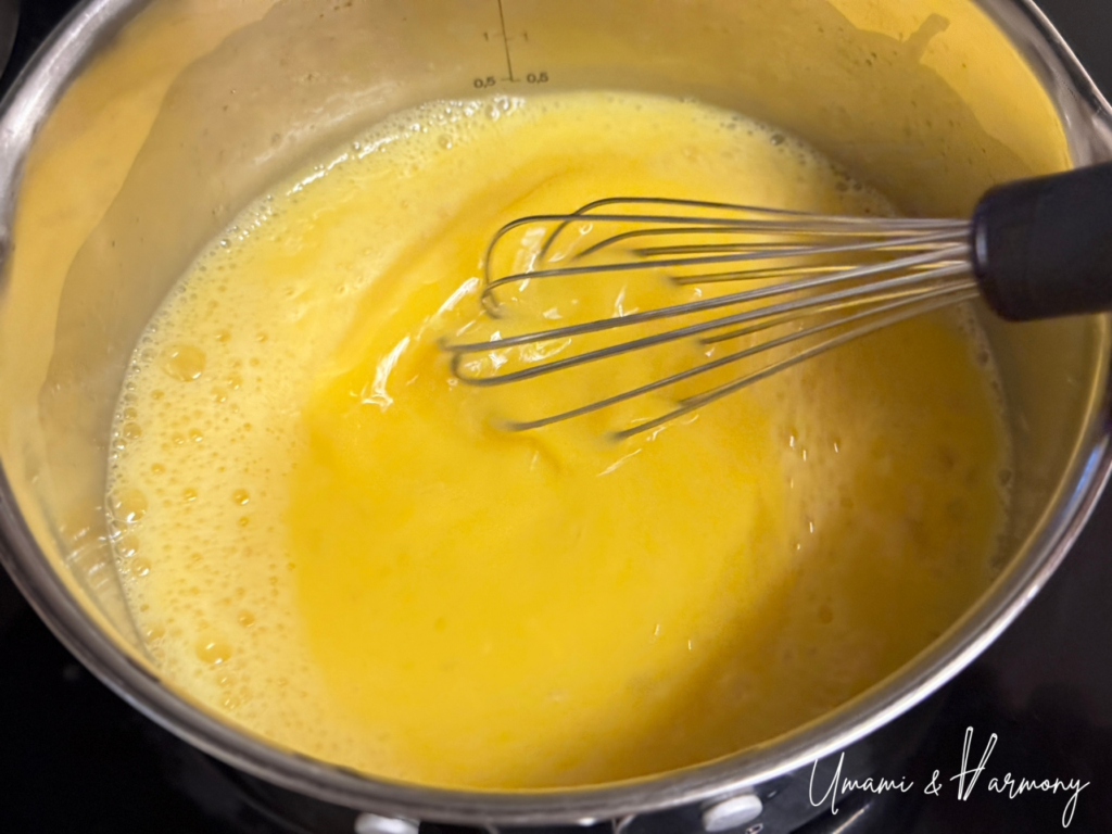 Eggs beaten with sugar, salt, and sake in a bowl