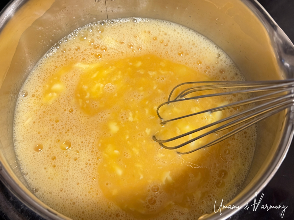 Egg mixture being stirred in a pot