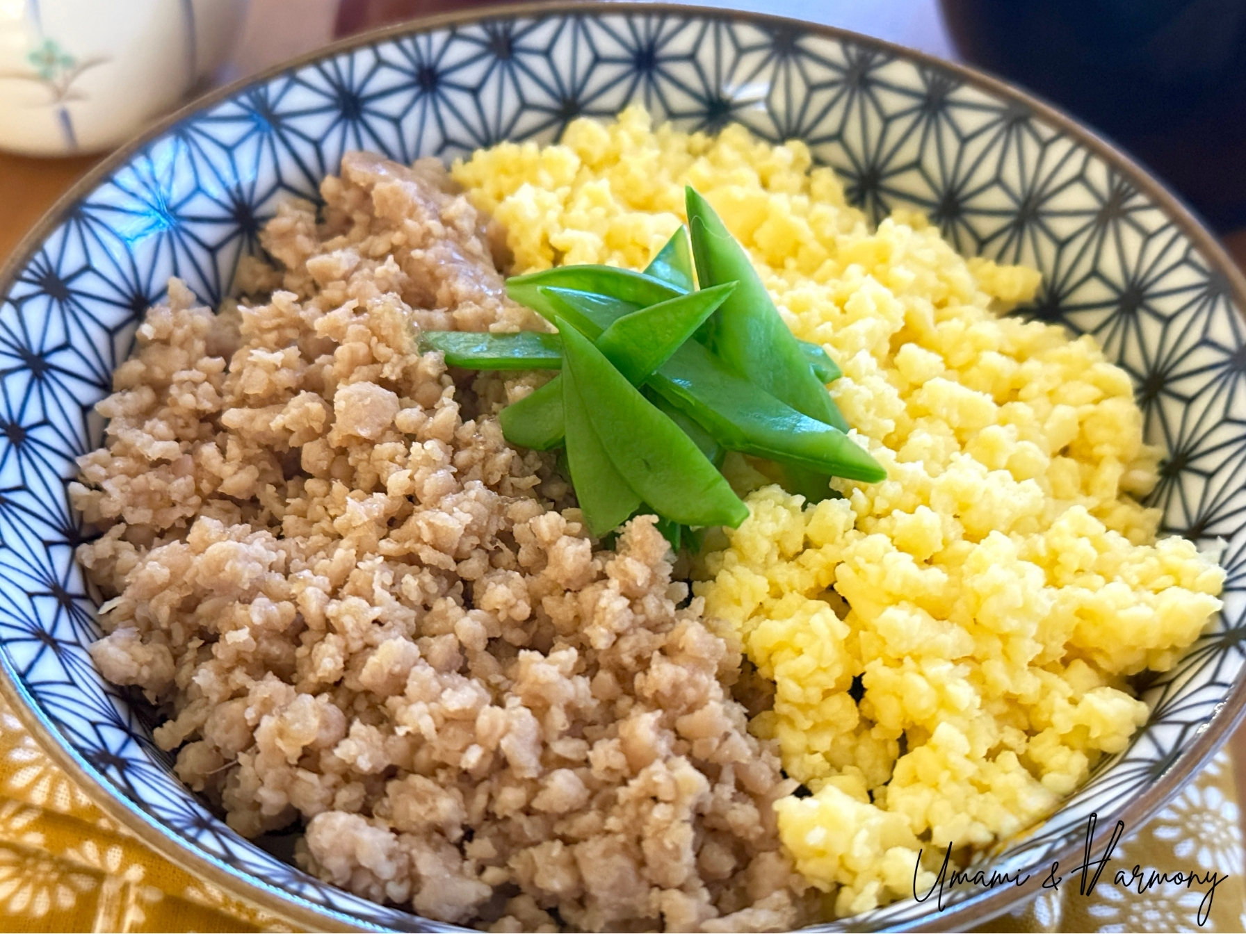 Soboro Don served in a bowl with ground chicken, scrambled eggs, and snow peas