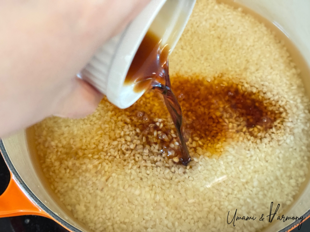 Rice and seasonings added to a pot before cooking