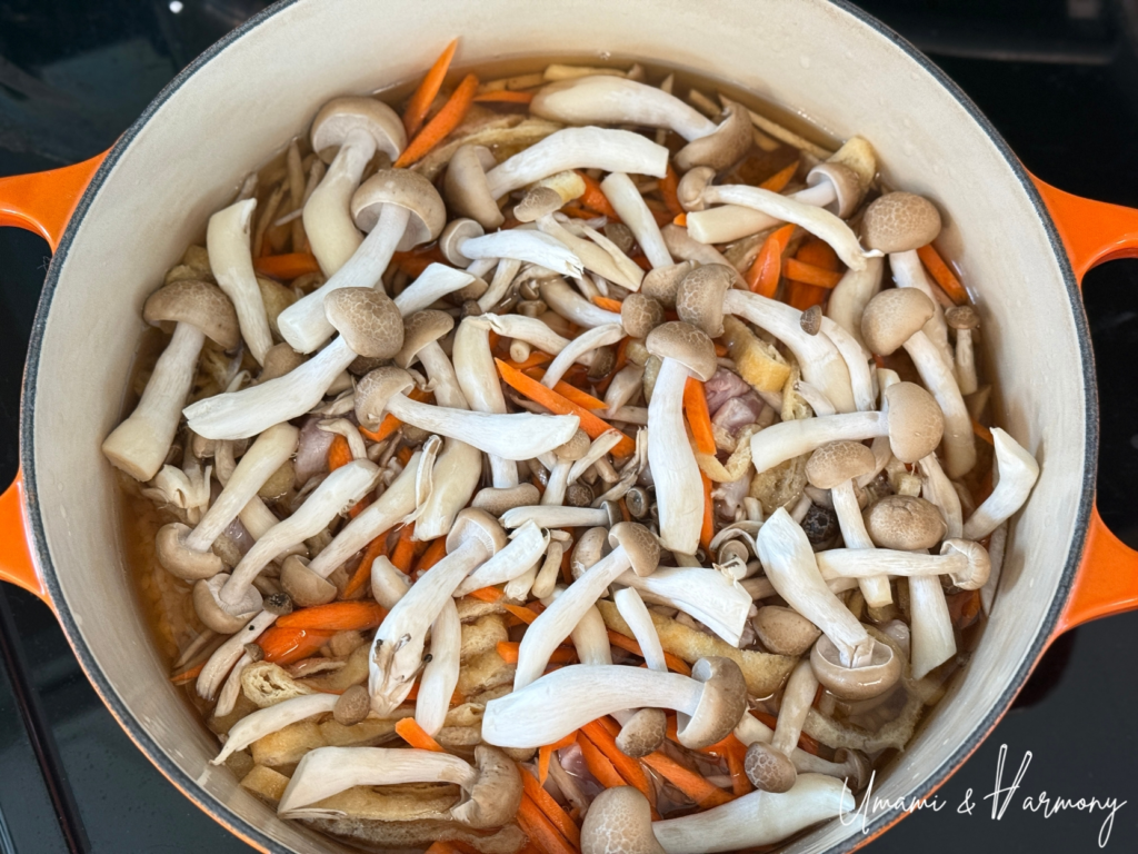 Ingredients layered on top of rice before cooking without stirring
