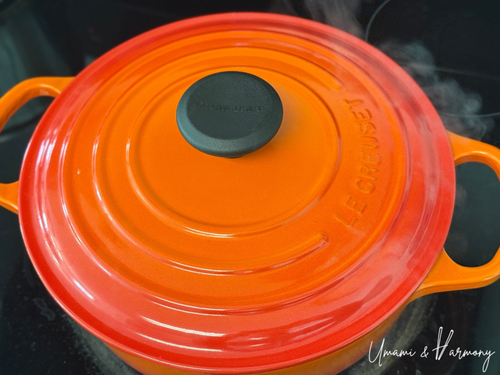 Gomoku takikomi gohan cooking in a pot with the lid on