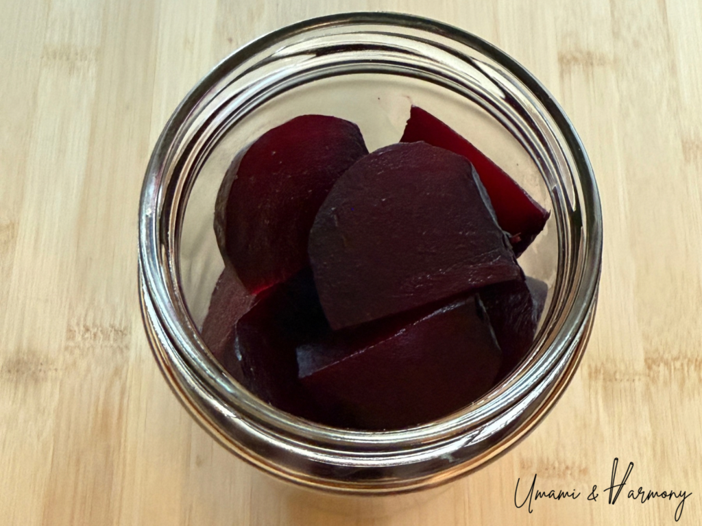Beet wedges placed in a clean jar for pickling