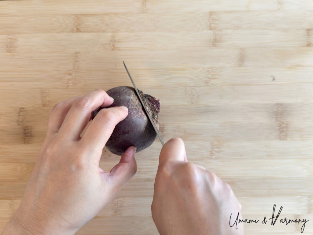 A beet being trimmed before roasting