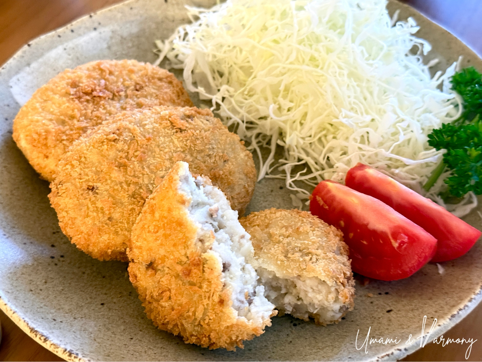 Croquette cut in half to show the fluffy potato and beef filling inside