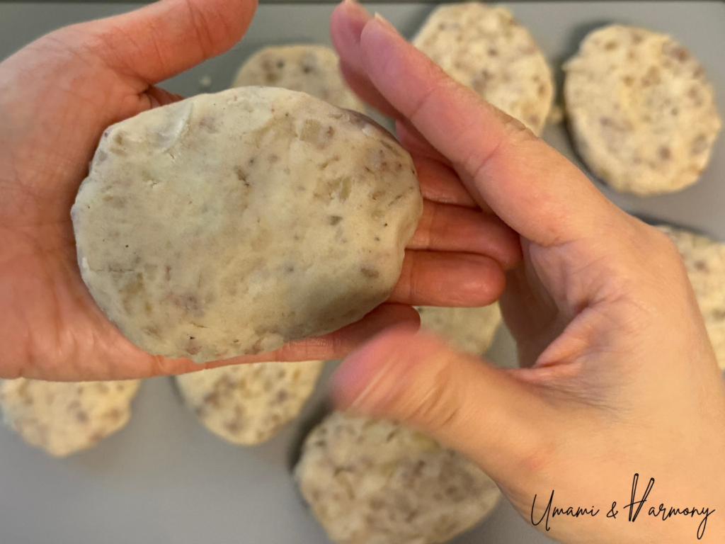 Croquettes being shaped into small oval patties