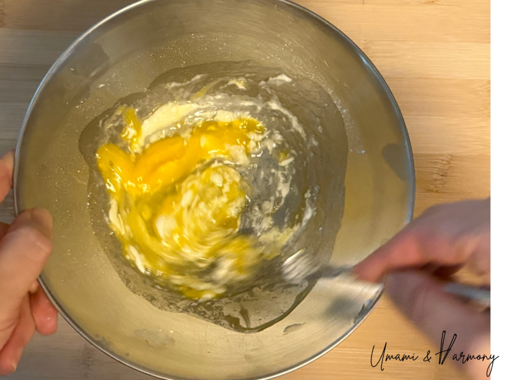 A egg being beaten in a bowl with flour