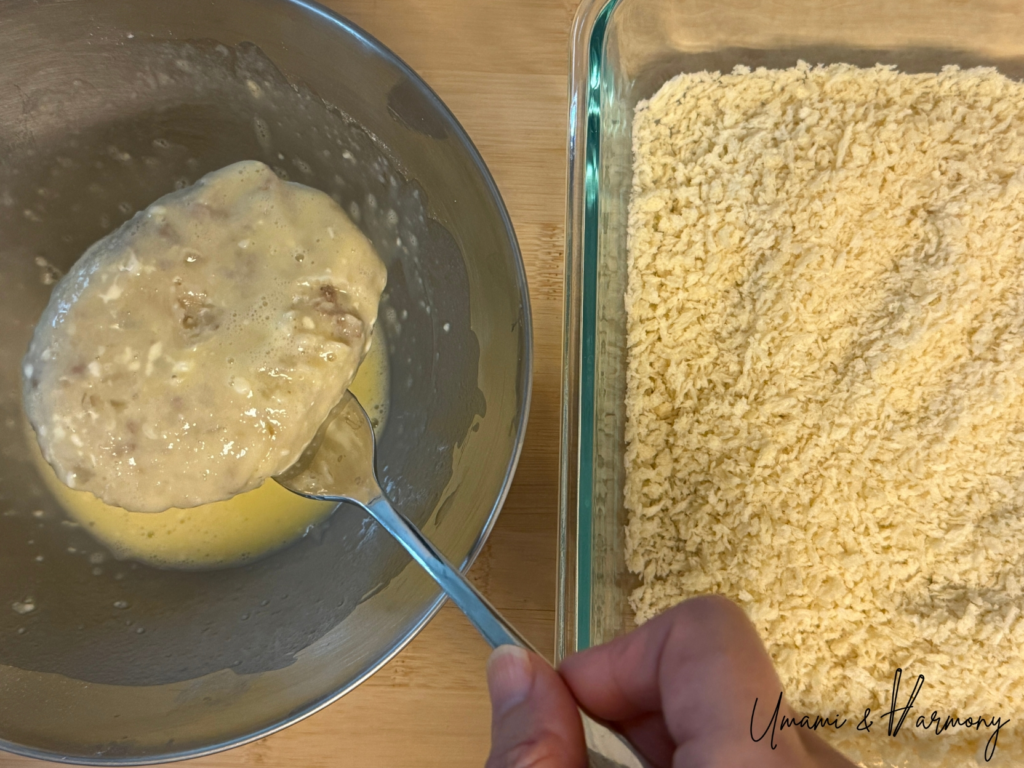 Croquettes being dipped in beaten egg