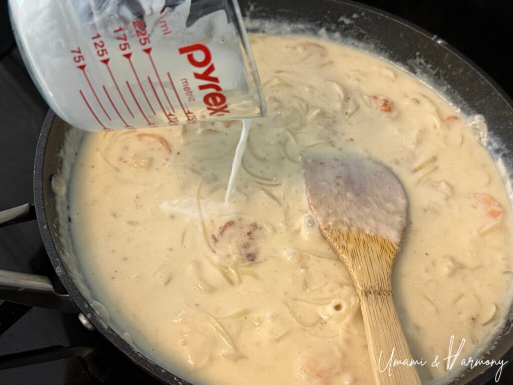Heavy cream being added to create a creamy white sauce