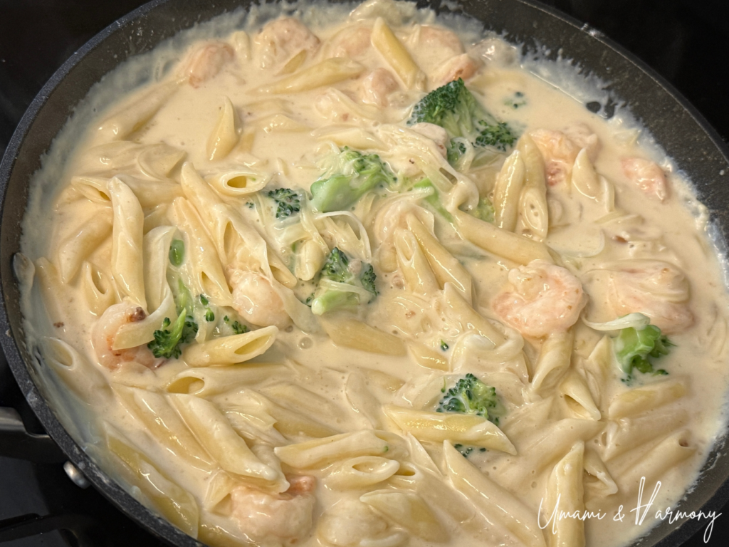Penne pasta and broccoli mixed into the creamy sauce