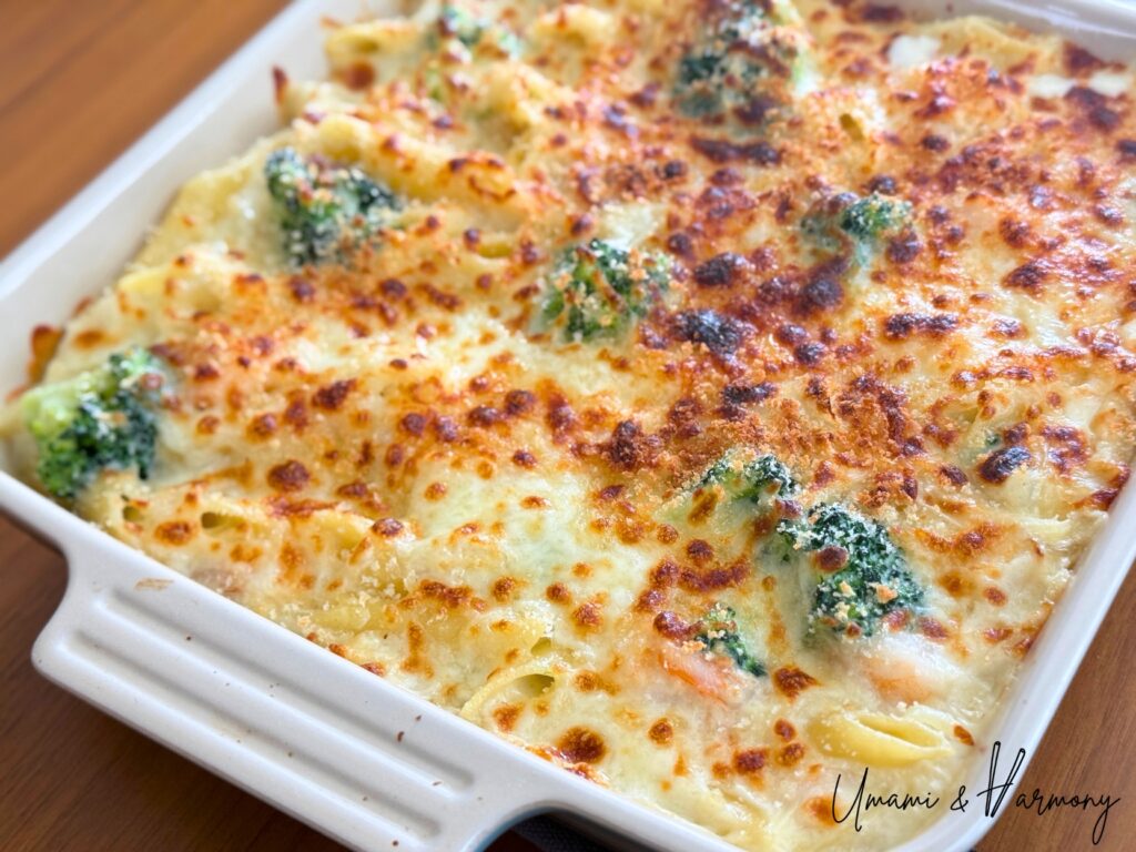 Close-up of creamy shrimp macaroni gratin with crispy cheese topping