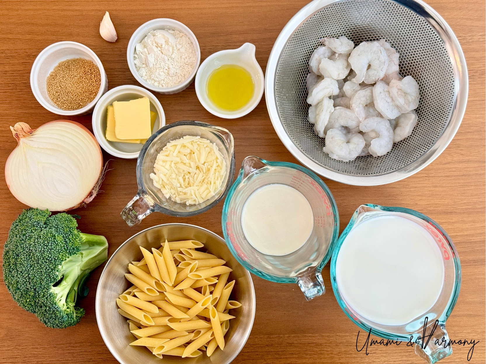 Ingredients for shrimp macaroni gratin including shrimp, penne pasta, broccoli, onion, milk, heavy cream, butter, cheese etc. 