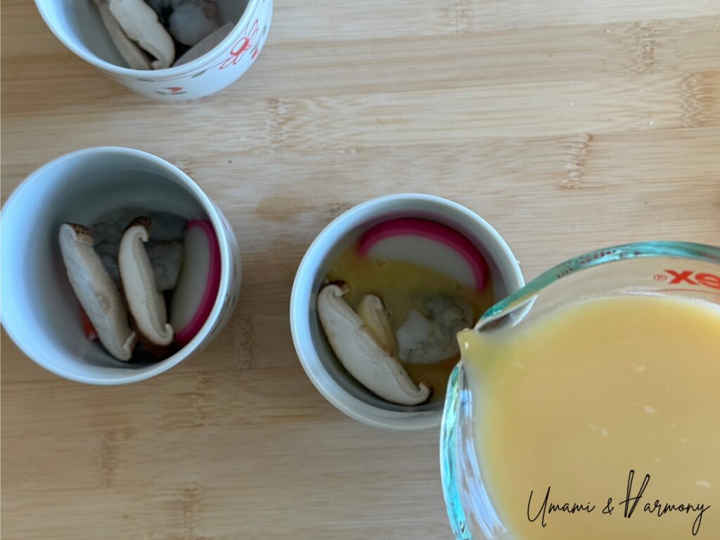 Egg mixture being poured into chawanmushi cups