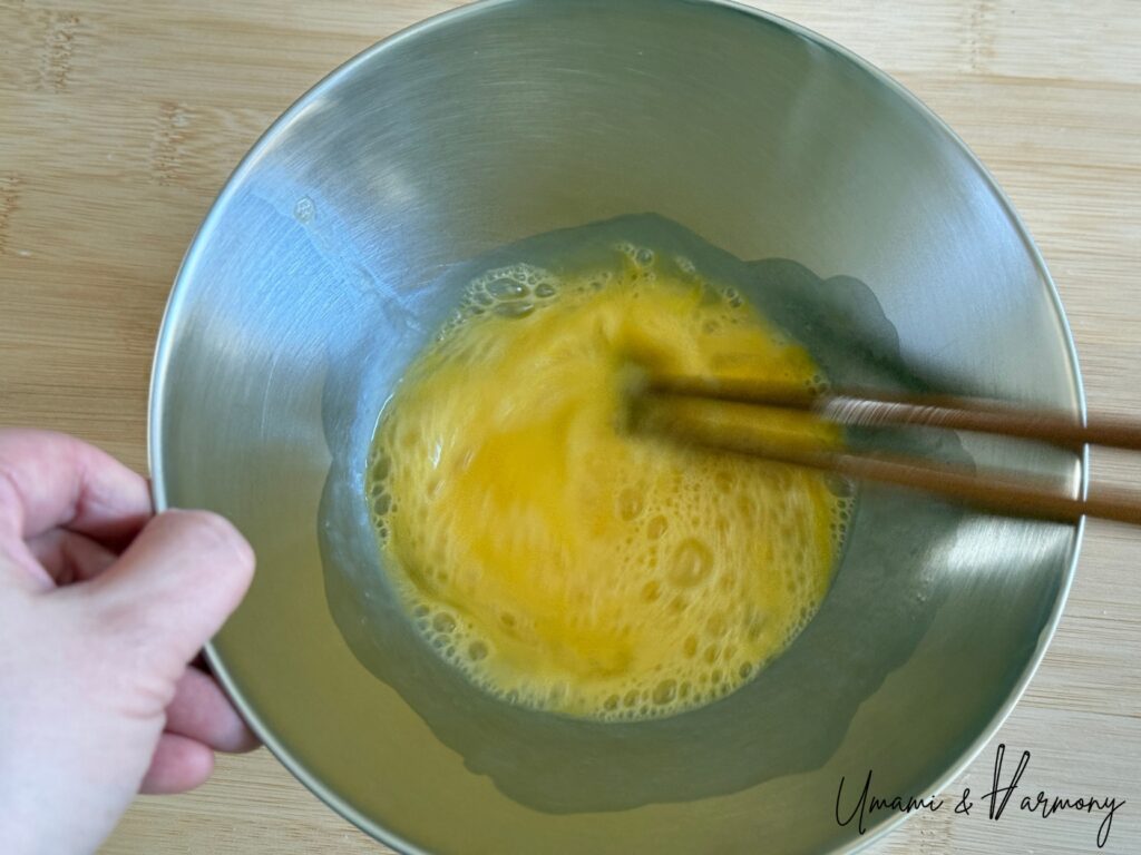 Eggs being beaten in a bowl for chawanmushi