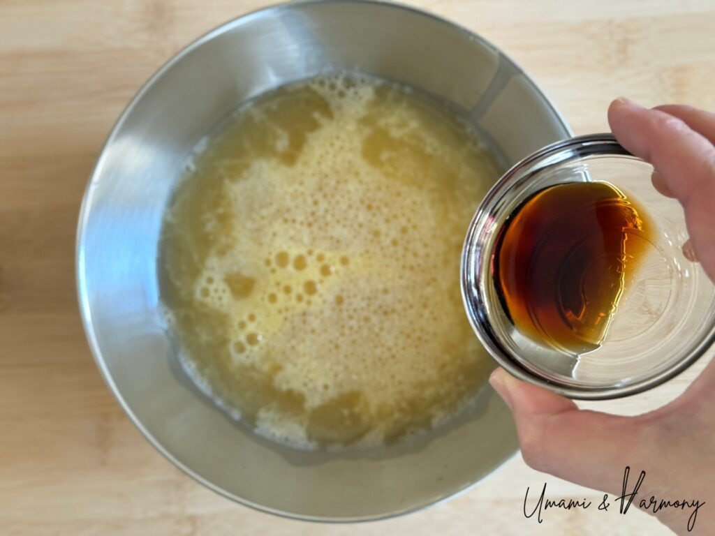 Light soy sauce being added to egg mixture