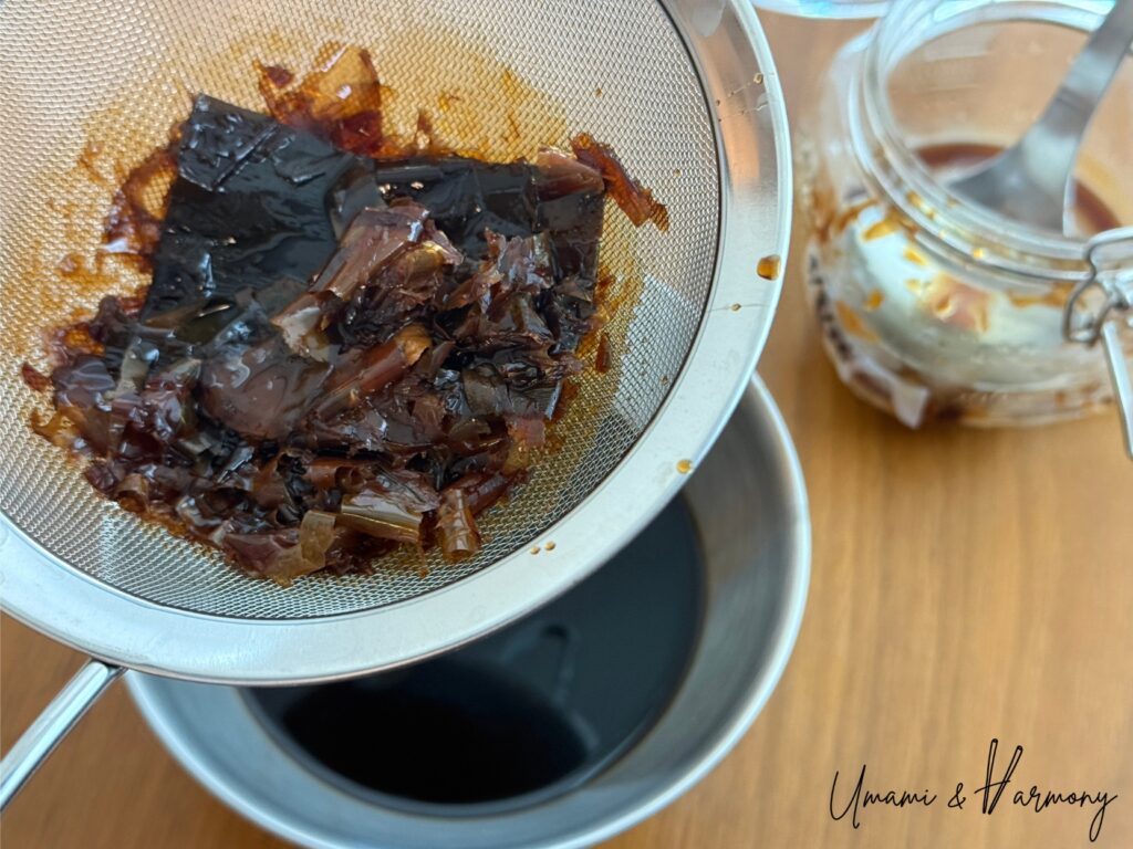 Ponzu sauce being strained through a fine mesh sieve