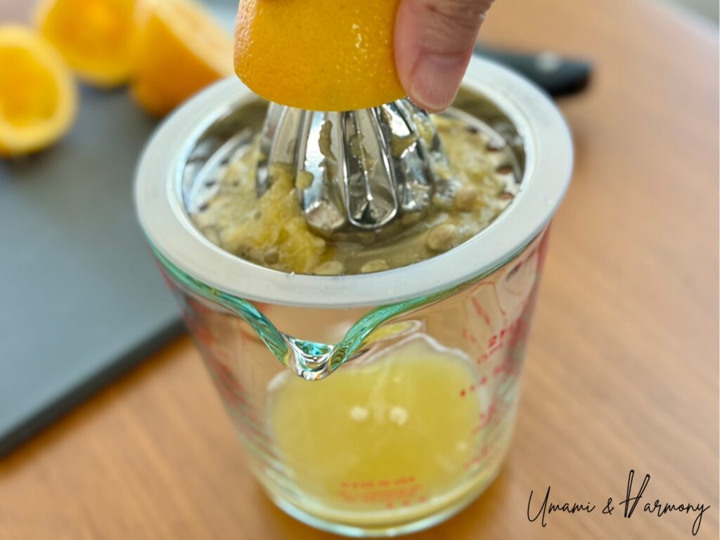 Meyer lemons being squeezed to make fresh citrus juice for ponzu