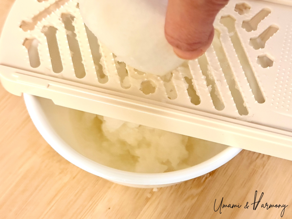 Daikon radish being grated to make daikon oroshi