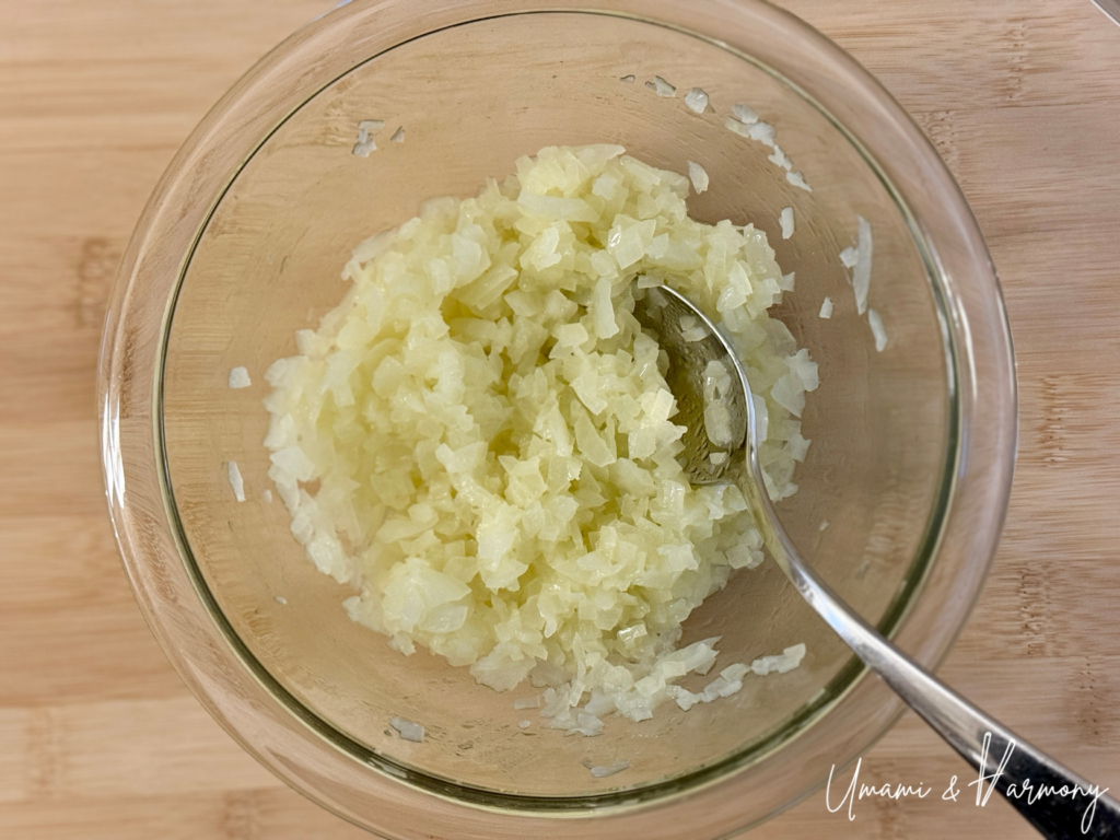 Cooked chopped onion being stirred after microwaving