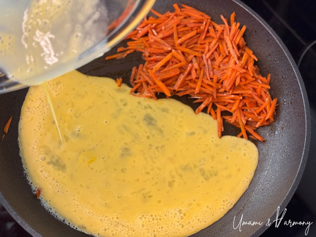 Beaten eggs being poured into the pan