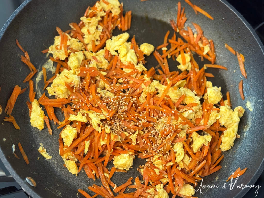 Eggs being mixed with carrots to finish ninjin shirishiri