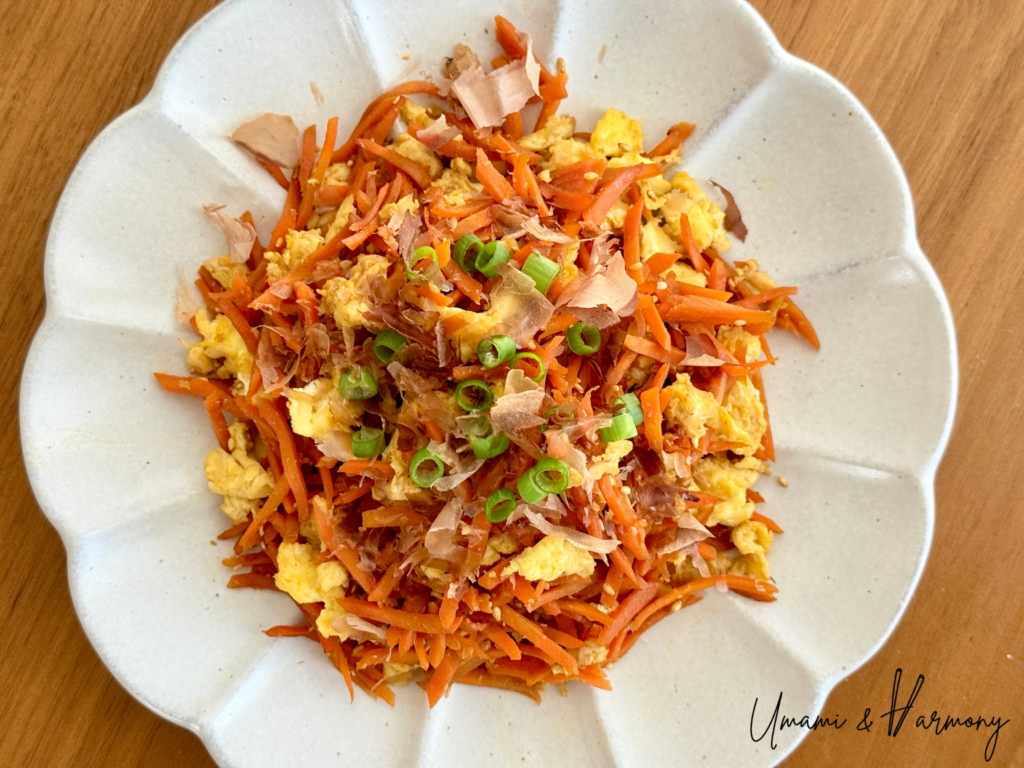 Japanese ninjin shirishiri carrot stir-fry served with bonito flakes and green onion
