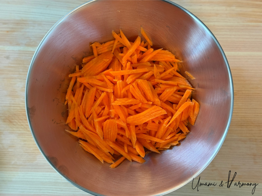 Julienned carrots in a bowl prepared for ninjin shirishiri