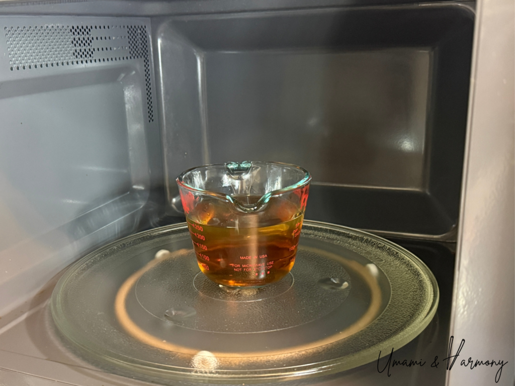 Dashi mixture being warmed in a microwave-safe container