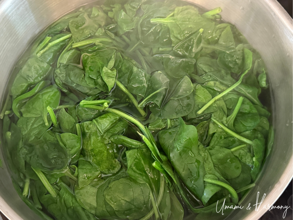 Baby spinach being blanched in salted boiling water